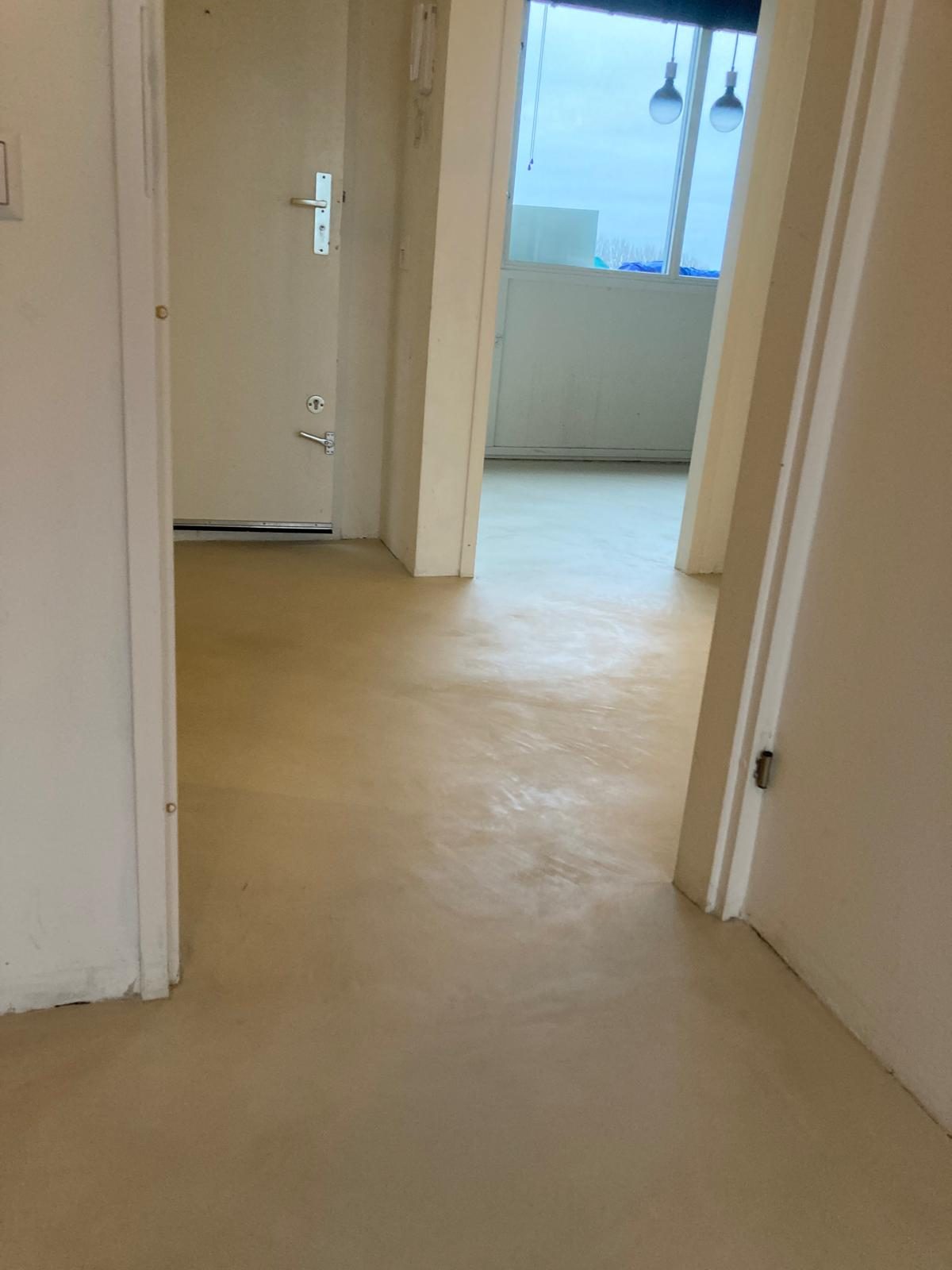 Finished microcement floor in a Dutch family home — seamless from wall to wall