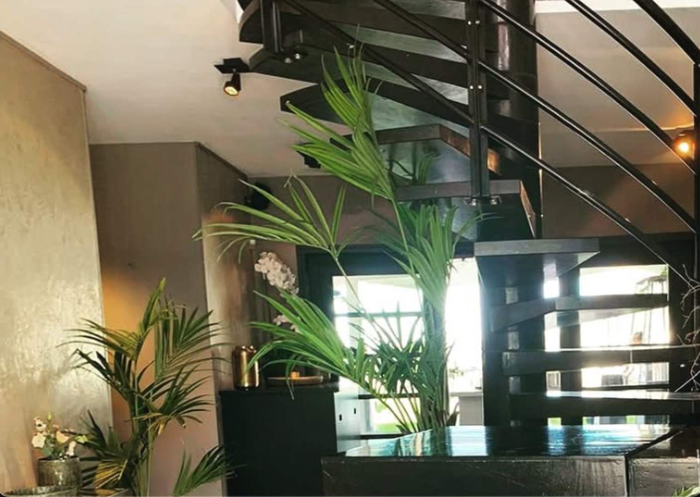 Commercial entrance with bronze plaster and spiral staircase