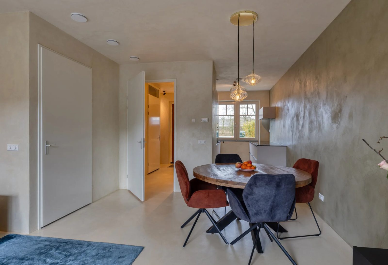 Dining area with sage microcement wall