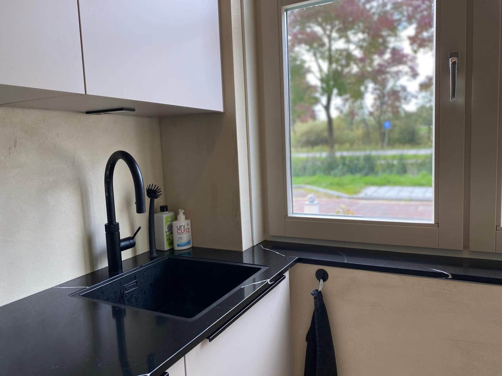 Kitchen with sage microcement splashback