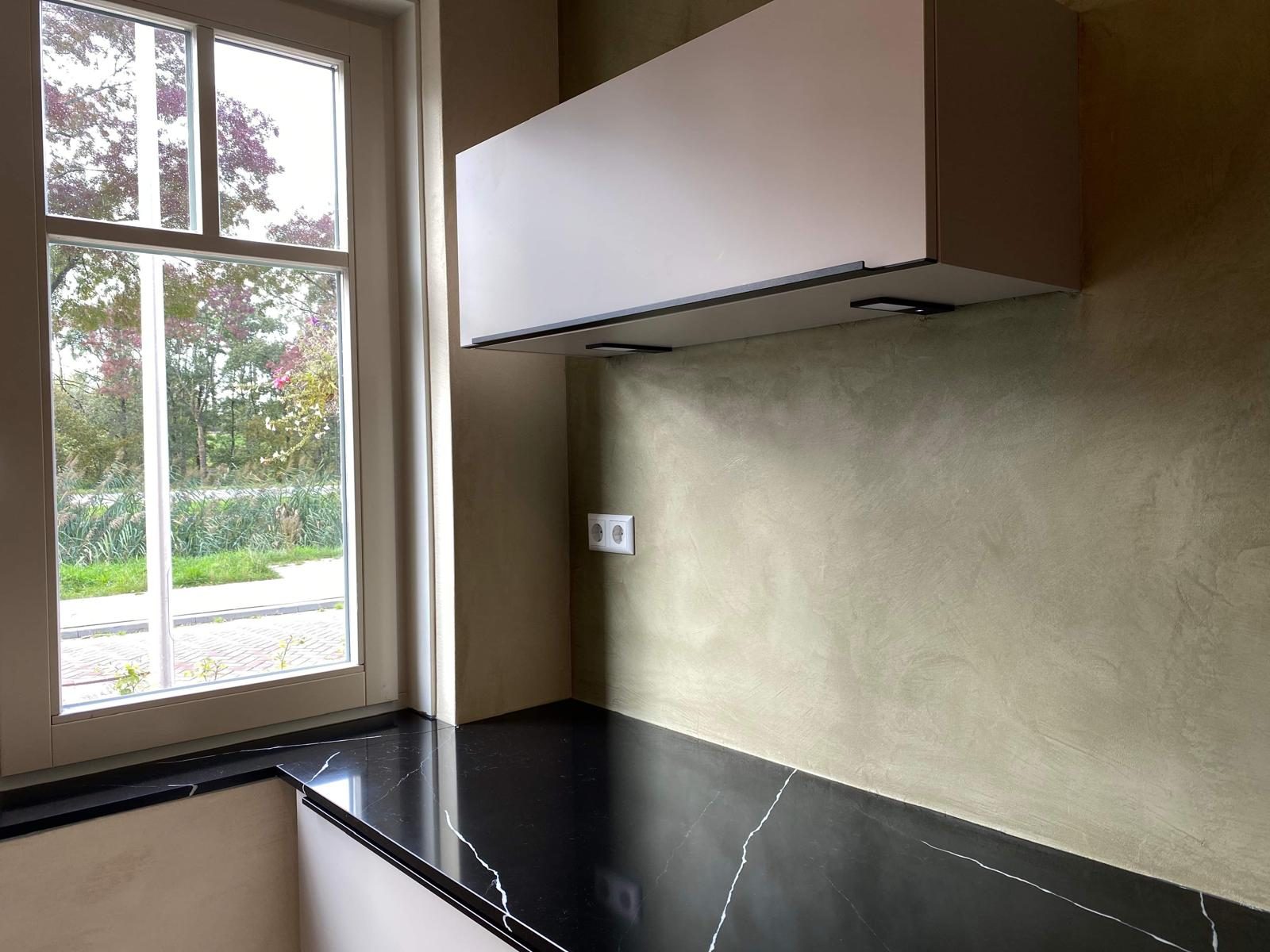 U-shape kitchen with seamless microcement walls